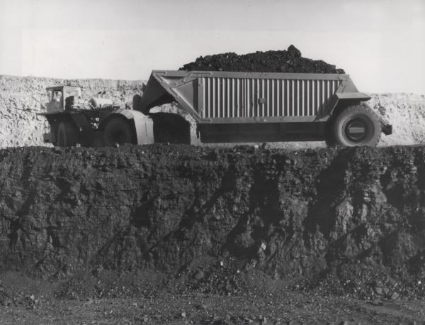Black and white photo of a dump truck full of coal