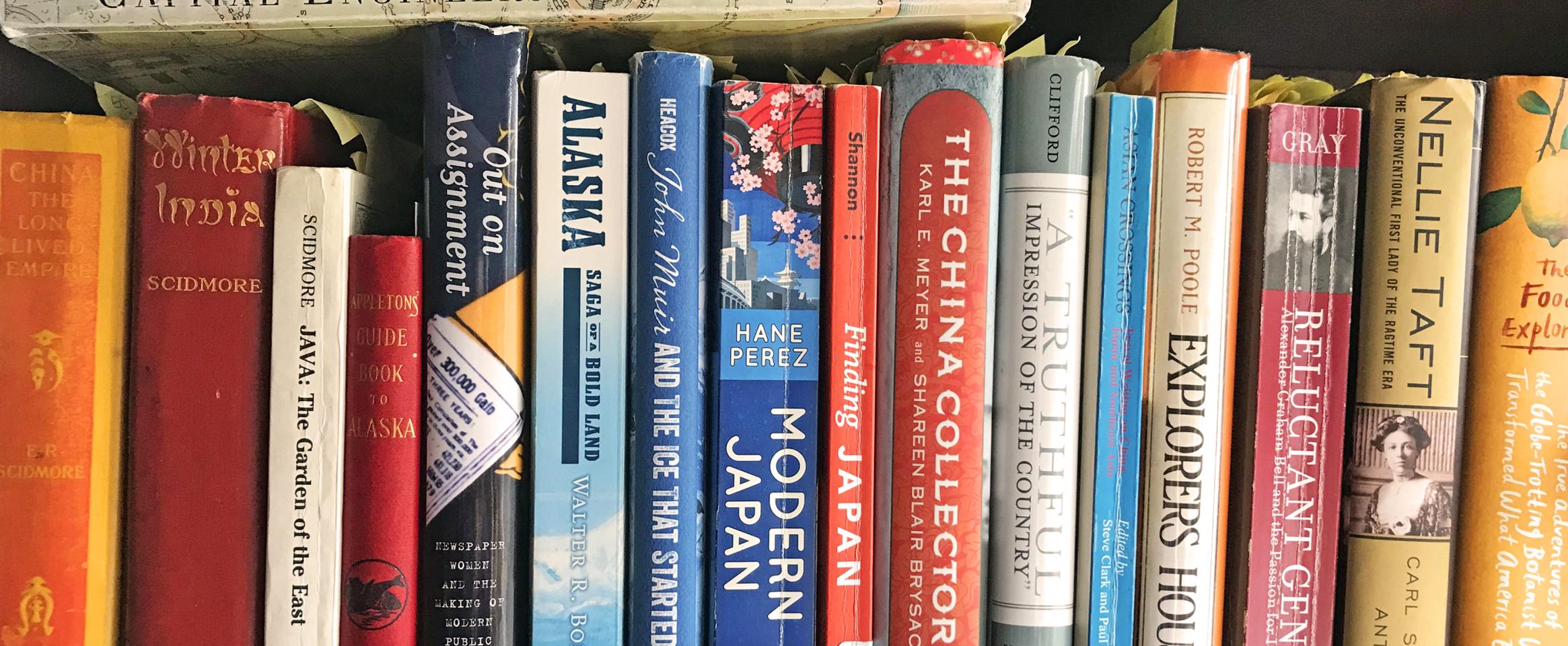 Horizontal photo of a shelf of books used by Diana P. Parsell for research on forthcoming book, "Eliza Scidmore: The Trailblazing Woman Behind Washington's Cherry Trees" Photo by Diana Parsell