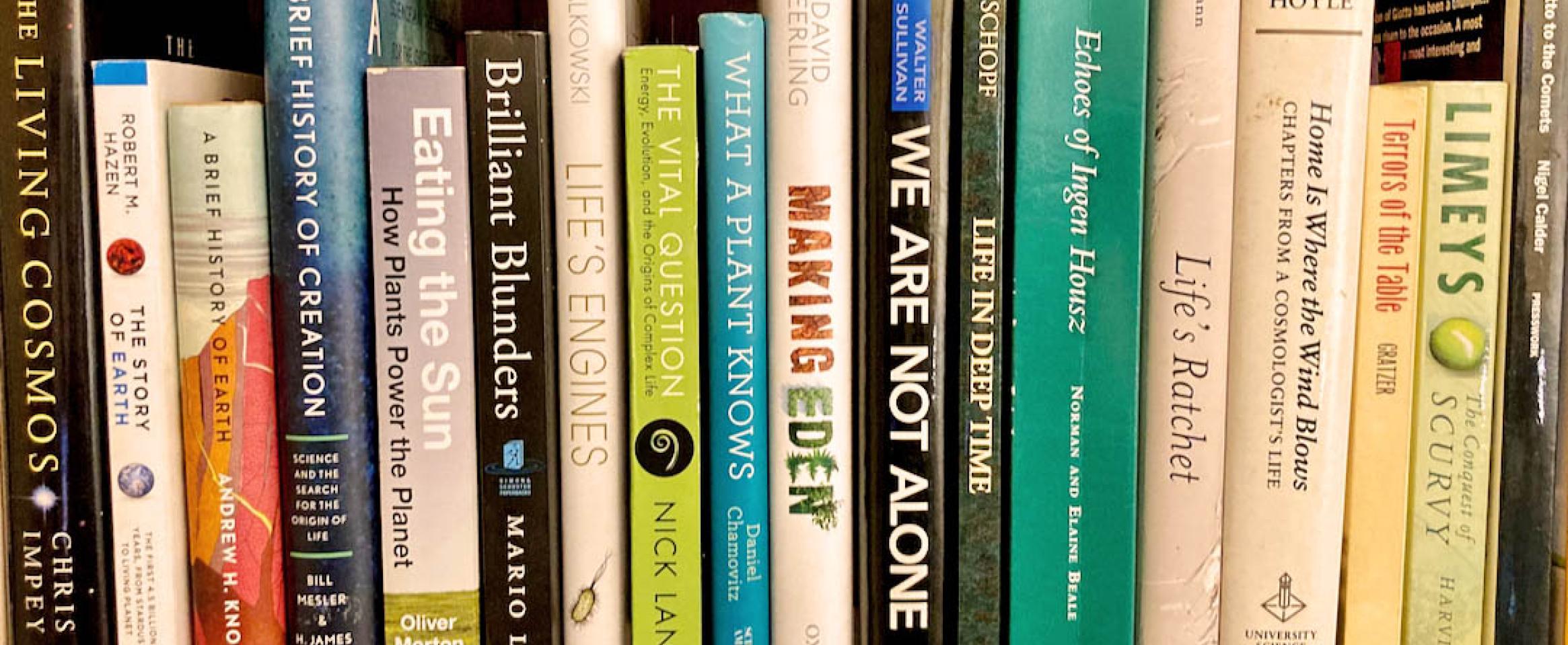 Rectangular photo of a close up view of books on Dan Levitt's bookshelv. Image credit Dan Levitt