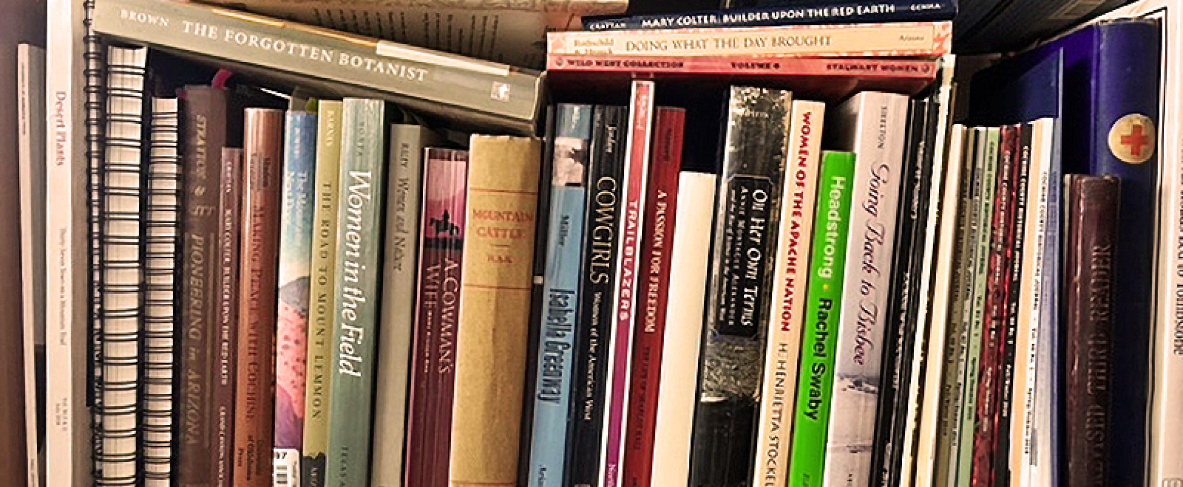 Rectangular photo of Wynne Brown's book shelf with titles about women in the U.S. West. Photo credit Wynne Brown.