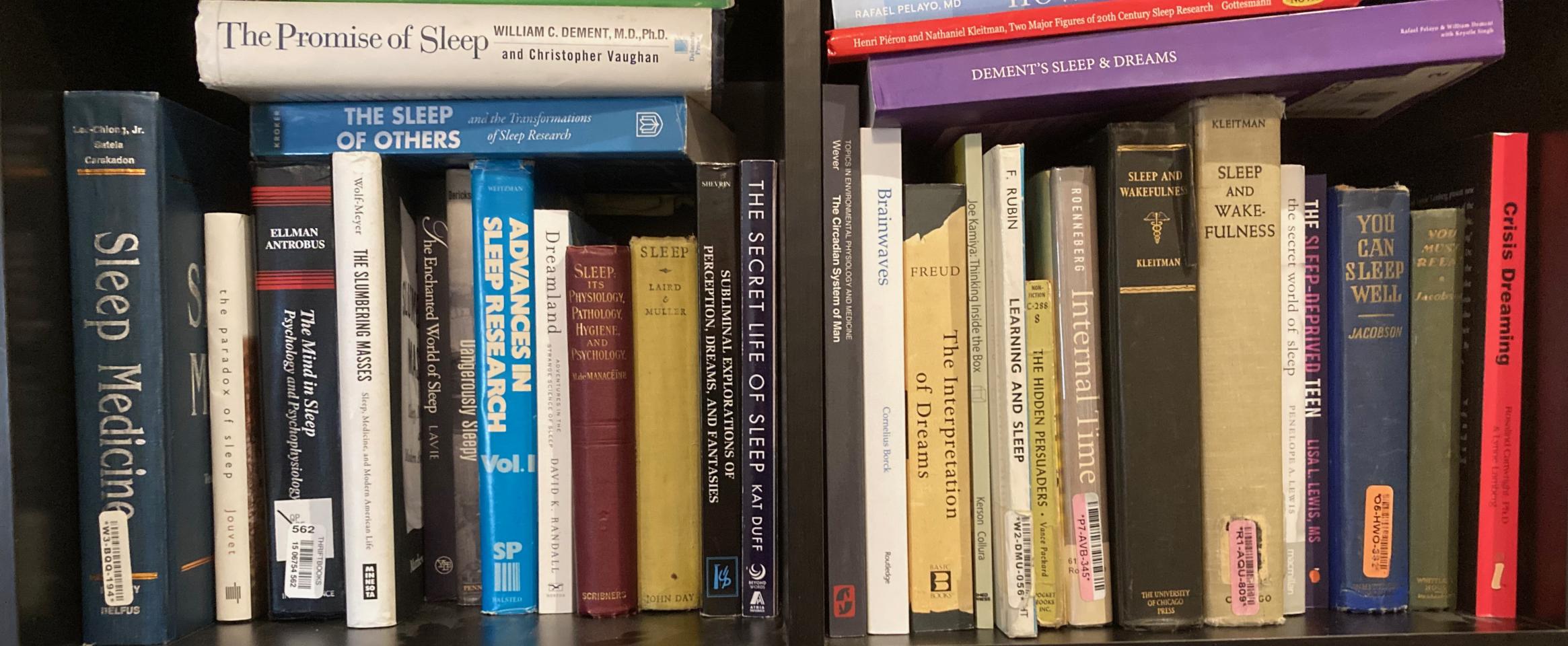 Rectangular photo of Kenneth Miller’s office bookshelf showing titles on sleep, sleep disorders, chronobiology, and dreams. Photo credit Kenneth Miller.