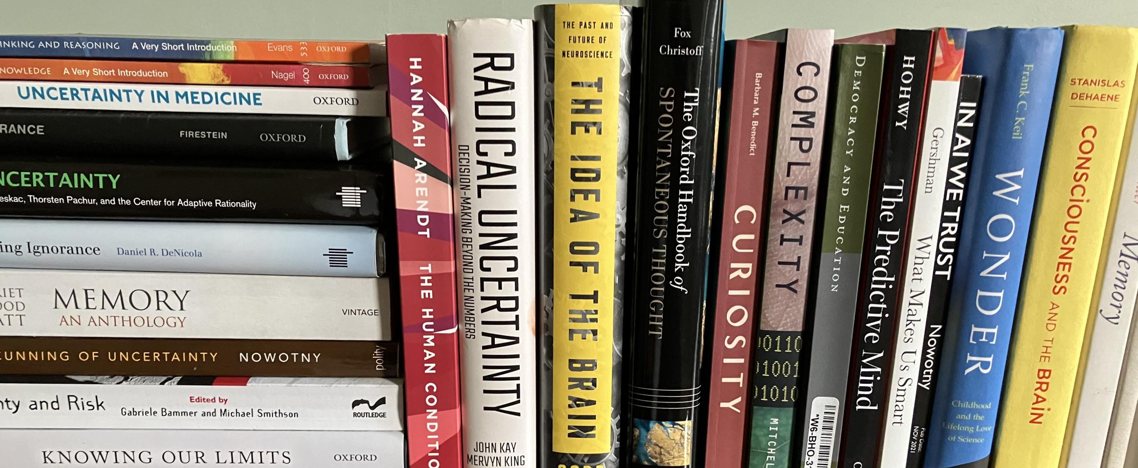 Rectangular photo of Stacey Colino’s office bookshelf with titles on dogs, happiness, and well-being. Photo credit Stacey Colino.