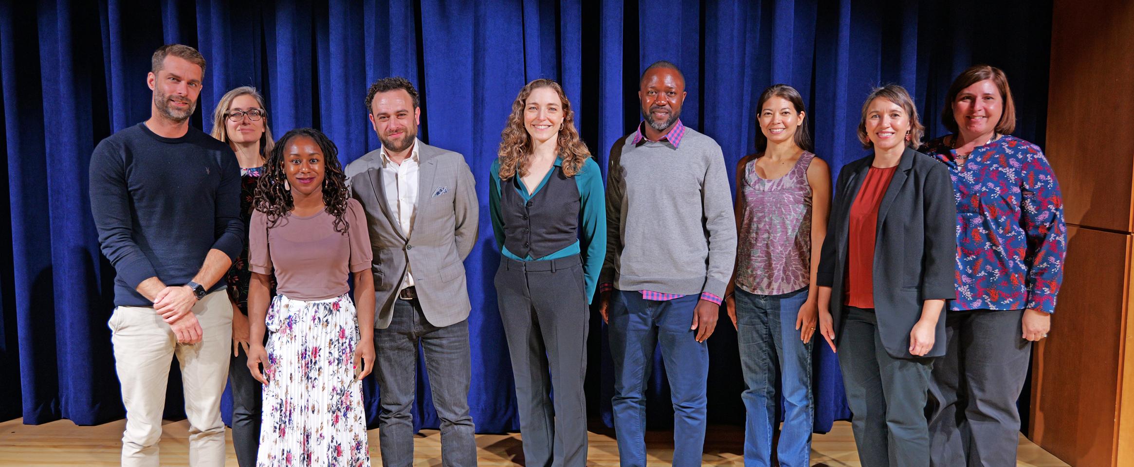 Horizontal photo of N A S W award winners and N A S W volunteers off different genders and attire standing together on stage. Photo by Casey A. Cass University of Colorado Boulder