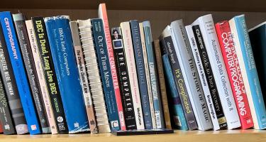 Rectangular photo of Simson Garfinkel’s office bookshelf showing works on computer history and science, privacy, and freedom. Photo credit: Simson Garfinkel.