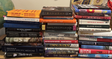 Rectangular photo of Starre Vartan’s office bookshelf showing works on gender, gender medicine, women’s rights, women’s health, and athletic performance. Photo credit: Starre Vartan.