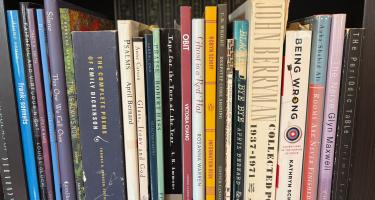 Rectangular photo of Deirdre Lockwood’s office bookshelf showing many books of poetry, some by pivotal twentieth-century poets such as John Berryman and Robert Hass, and others by younger poets. Photo credit: Deirdre Lockwood.