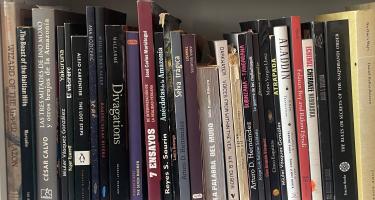 Rectangular photo of Brad Fox’s office bookshelf showing works on the Amazon, folk healing, plants, and indigenous cultures. Photo credit: Brad Fox.