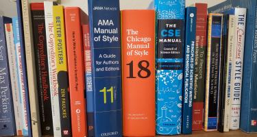 Rectangular photo of Barbara Gastel’s office bookshelf showing books on writing, editing, fact-checking, and copy-editing, along with several standard style manuals. Photo credit: Barbara Gastel
