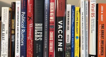  For bookshelf photo: Rectangular photo of Joanne Kenen’s office bookshelf showing works on influenza, vaccines, and other public health issues, journalism, misinformation, mass audiences, political rumors, and medical myths. Photo credit: Joanne Kenen.