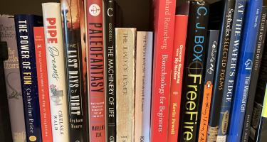 Rectangular photo of Ted Anton’s office bookshelf with titles on biotechnology and literature, reflecting both his book’s topic and his work as a professor of English at DePaul University. Photo credit Ted Anton.