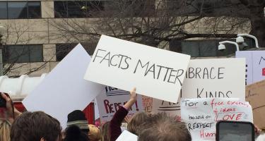 Rectangular photo of Women’s March in Washington DC, January 21, 2017, with signs reading “Facts Matter.” Photo credit Brooke Borel.