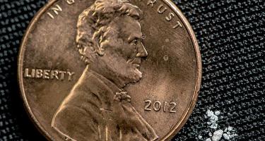 Two milligrams of fentanyl alongside a penny for scale. This dose is considered to be lethal for a 150-pound human, with this estimate extrapolated from data in monkeys. Credit: United States Drug Enforcement Administration (Creative Commons License).