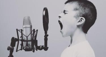 Child speaking into a microphone