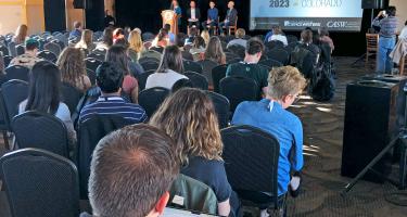 Square photo of attendees listening to Rebecca Boyle introduce the Reporting on Indigenous Communities plenary at Science Writers 2023. Photo by Ben Young Landis.