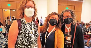 Horizontal photo of N A S W members Kendall Powell, Jenny Cutraro, and Sarah Webb wearing masks and excited to participate as mentors at the Science Writers 2023 Annual Meeting. Photo by Ben Young Landis