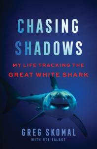 Cover of the book Chasing Shadows: My Life Tracking the Great White Shark by Greg Skomal with Ret Talbot (NASW Member) showing a white shark in the dark blue ocean.