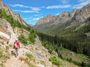 Hiker and Redfish Canyon from Alpine Lake Trail in Sawtooth Wilderness