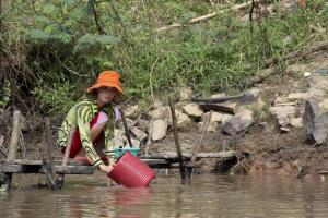 A photo of a Vietnamese woman on the Mekong River Delta.