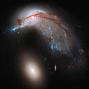 The "egg" (NGC 2937) is actually tearing its mom (NGC 2936) apart. CREDIT: NASA, ESA and the Hubble Heritage Team (STScI/AURA)