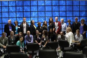 Attendees and UC-HiPACC staff in front of an image from the Bolshoi cosmological simulation on the 128-screen Hyperwall.