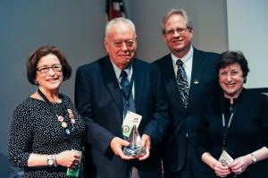 Cristine Russell, Ben Patrusky, Alan Boyle, and Joann Rodgers. Patrusky was presented with a commemorative crystal prism.