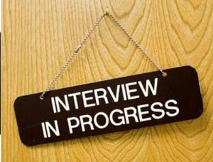 Sign on door reading "interview in progress"