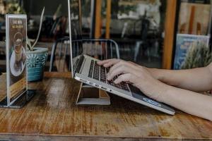 A picture of a person typing on a laptop