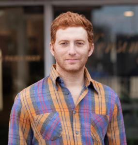 Portrait photo of Ryan Goldberg in an urban outdoor setting