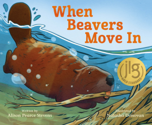 Cover of the book When Beavers Move In by Alison Pearce Stevens, showing an illustration of a beaver, mostly underwater, holding a tree branch in its mouth as it approaches a beaver dam. The colors are true to life, with the beaver in brown, the branches yellow and tan, the water blue, and the sky above a lighter blue. The title letters are in red at the top of the cover, and the names of the author and illustrator in pale yellow at the bottom of the cover.