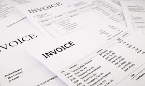 Stack of invoices image via Shutterstock
