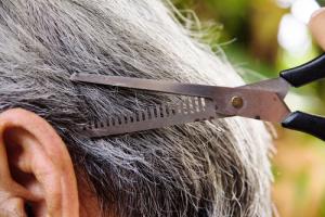 Cutting gray hair image via Shutterstock
