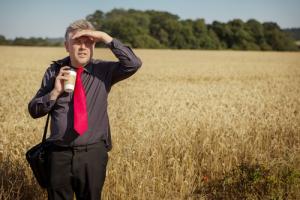 Man standing in field image via Shutterstock