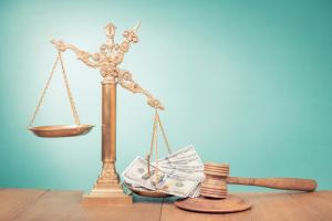 Justice scales and cash image via Shutterstock