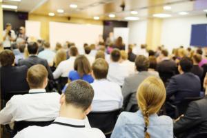 Conference room audience image via Shutterstock