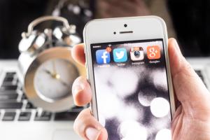 Social media icons on smartphone image via Shutterstock