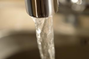 Water running from faucet image via Shutterstock