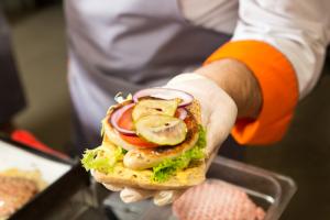 Preparing burger, image via Shutterstock