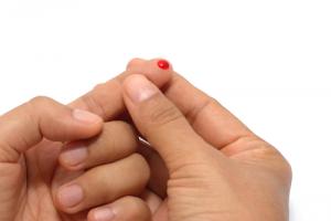 Blood drop on finger image via Shutterstock