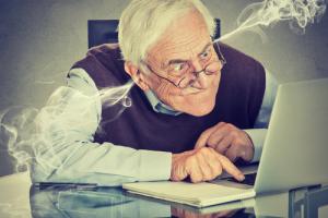 Angry man on laptop image via Shutterstock