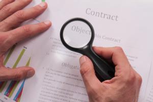 Contract and magnifying glass image by Shutterstock