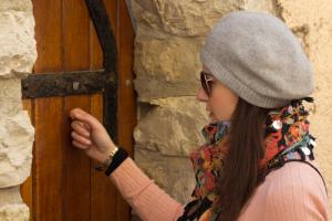 Woman knocking on door, image via Shutterstock